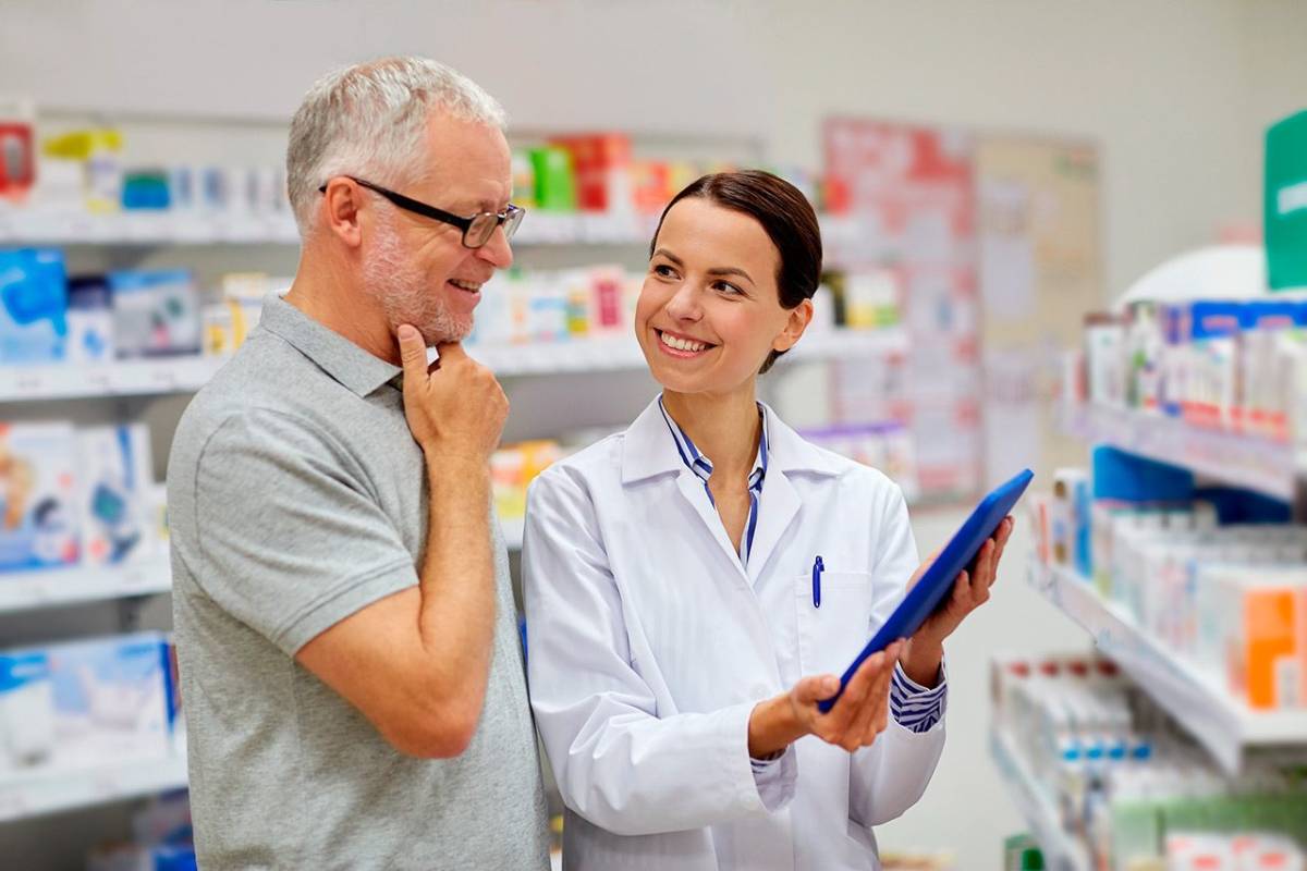 Pharmacist helping senior with prescriptions
