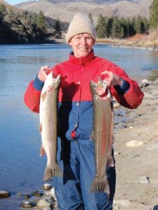 Holly Endersby, writer for Idaho Senior Independent, holds up two winter steelhead.