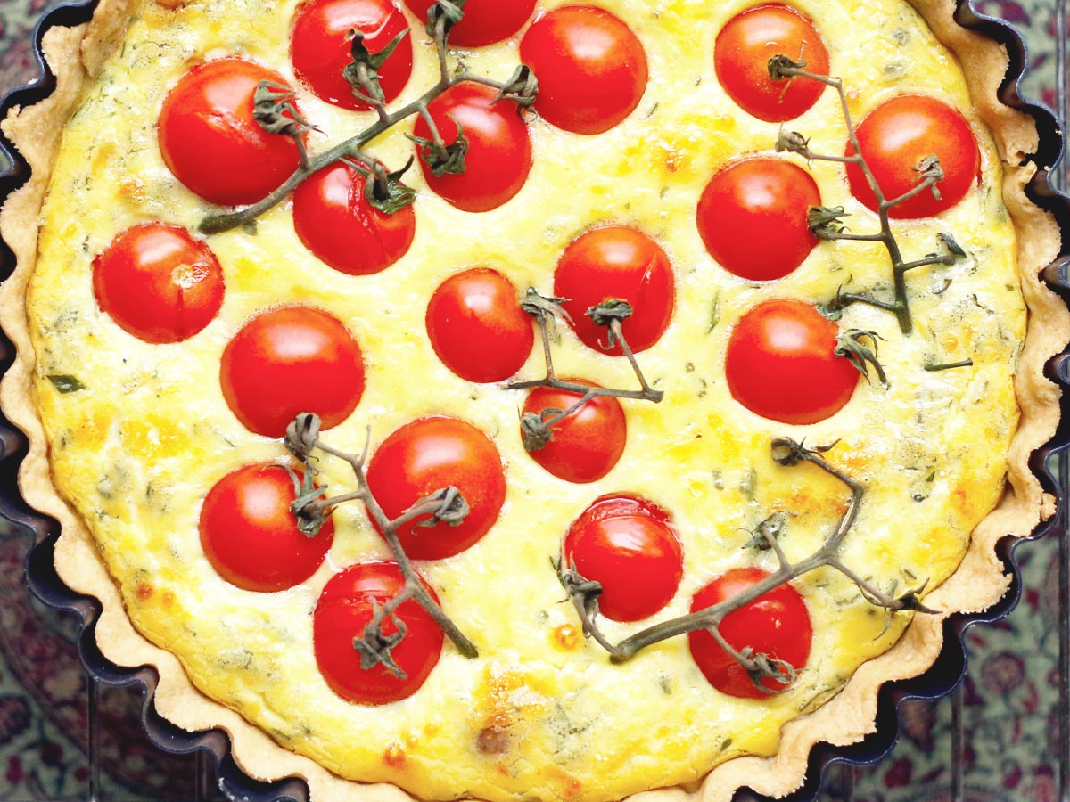Close-cropped image of a garlic & tomato quiche