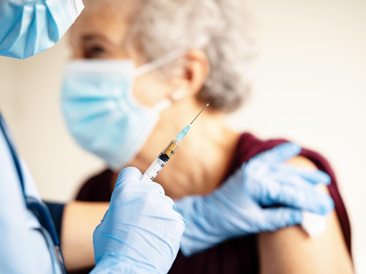 Photo of a senior women getting a vaccine shot