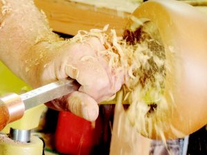 Close-up photograph of Carl Erickson's hands using a lathe