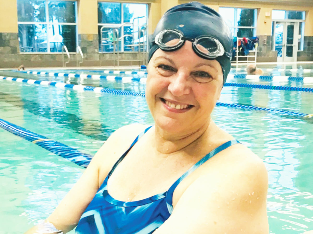 Photo of woman wearing a swim mask while standing in a swimming pool.