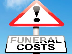 Photo illustration of a road sign with an exclamation point and text reading, "Funeral Costs" against a blue sky.
