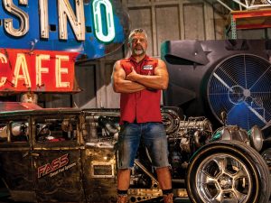 Rat Rods: Long, Low, Loud Photo of Steve Darnell originally from Billings, Mont., standing in front of his Rat Rod.