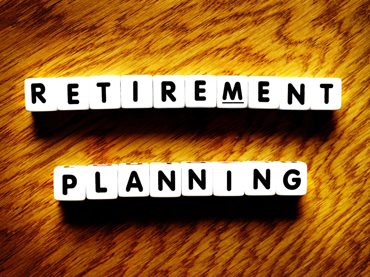 photo of lettered cubes spelling out "retirement planning" on a wooden background