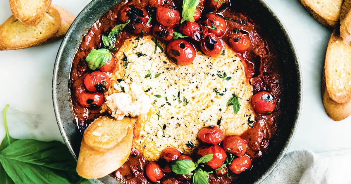 Closeup photo of baked tomato goat cheese dip, one of three comforting classic recipes