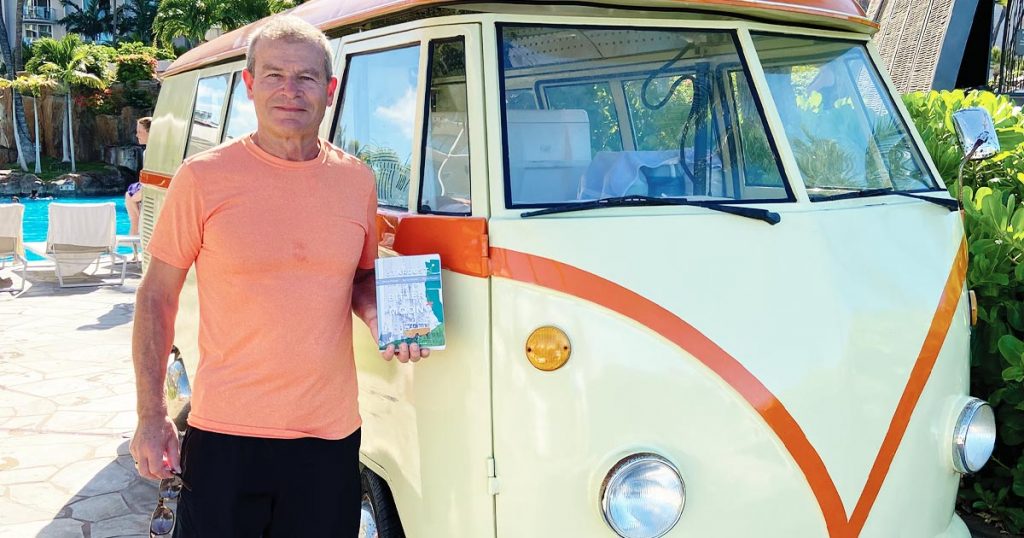 Photo of Dick Cvitanich of Sandpoint, Idaho, standing next to a VW bus.