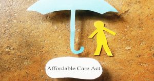 Photo illustration of a paper-cutout person standing under a paper-cutout umbrella. Caption reads "Affordable Care Act."