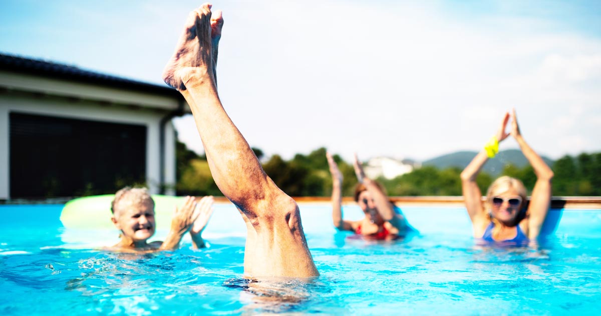 photo of seniors at an adult living community, swimming and having fun in a pool
