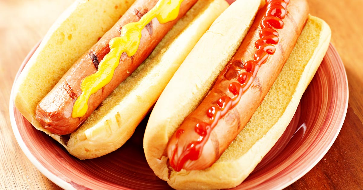 ultra processed food speeds brain decline: two hotdogs in buns, one with mustard, one with katsup