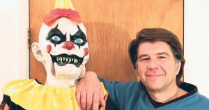 Mick Hoover of Mackay, Idaho, posing with one of his haunted house props