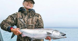 fishing in rural alaska: photo of a woman holding a caught salmon