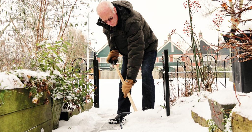photo of a senior man shoveling snow