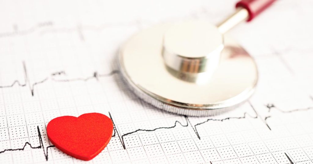 image of a heart shape and stethoscope on an ekg reading for an article about winter heart attack risks.