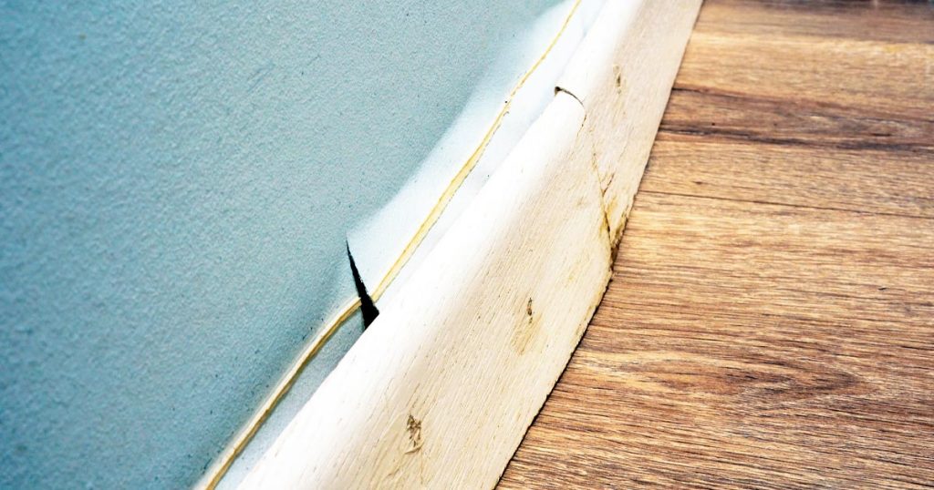 flood damage on baseboard trim for an article about misconceptions homeowners have about floods